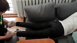 Young guy pays out his lolly with his feet