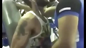 Gorgeous cheerful kiss at one's fingertips gym between two indians